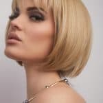 Blonde bob wig with side-swept bangs and sleek finish.